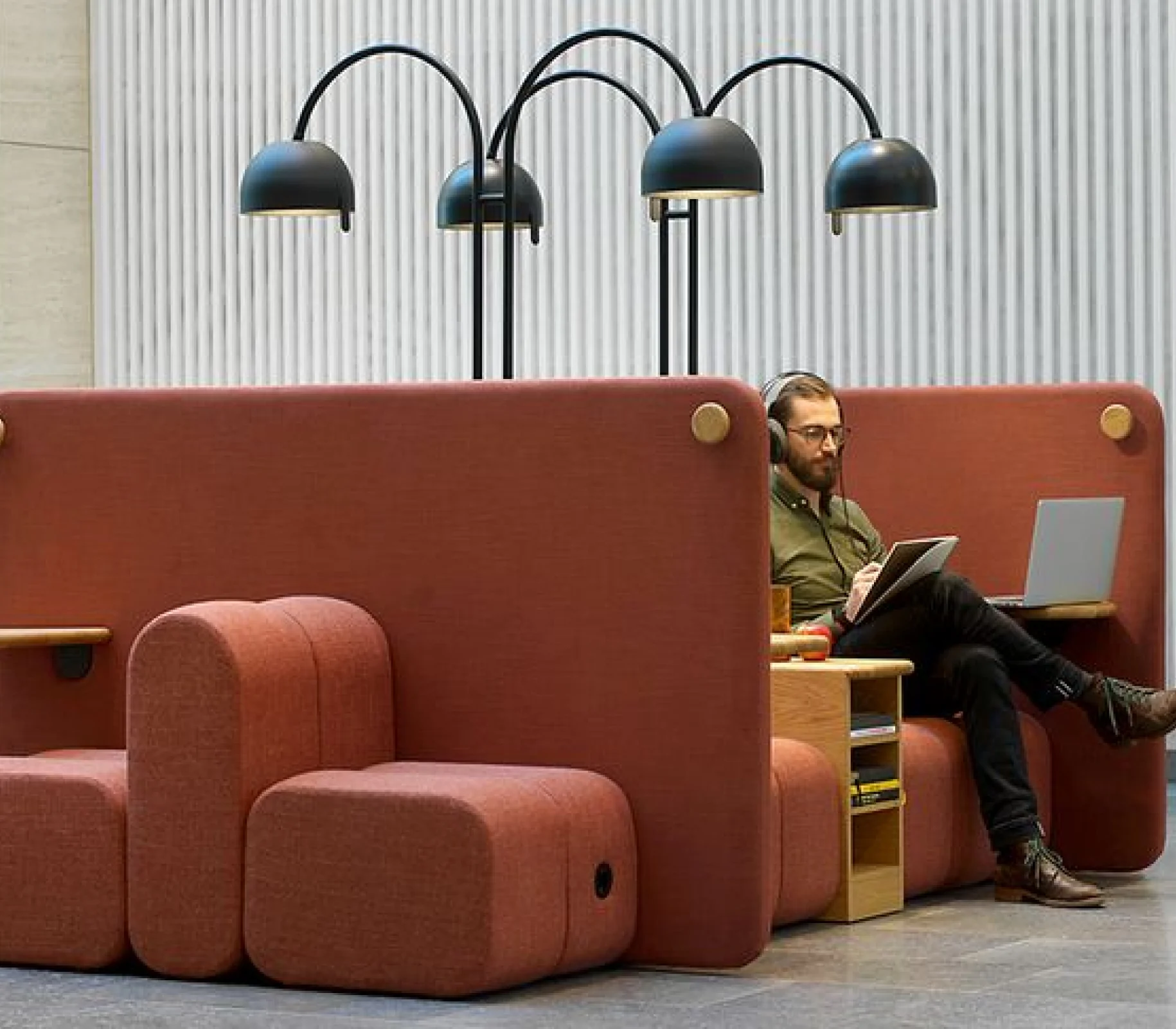 A man sitting on a couch using a laptop.