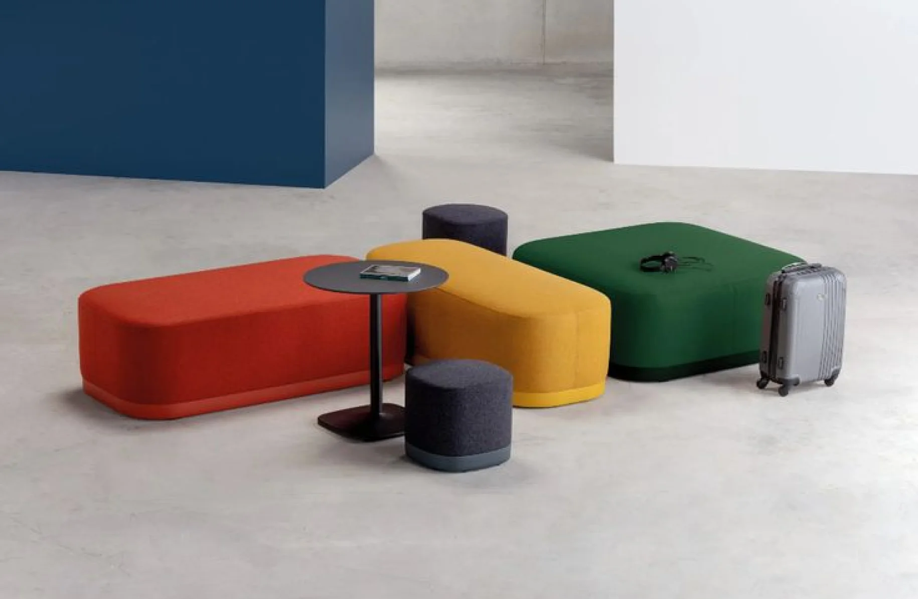 A group of different colored stools sitting next to each other.