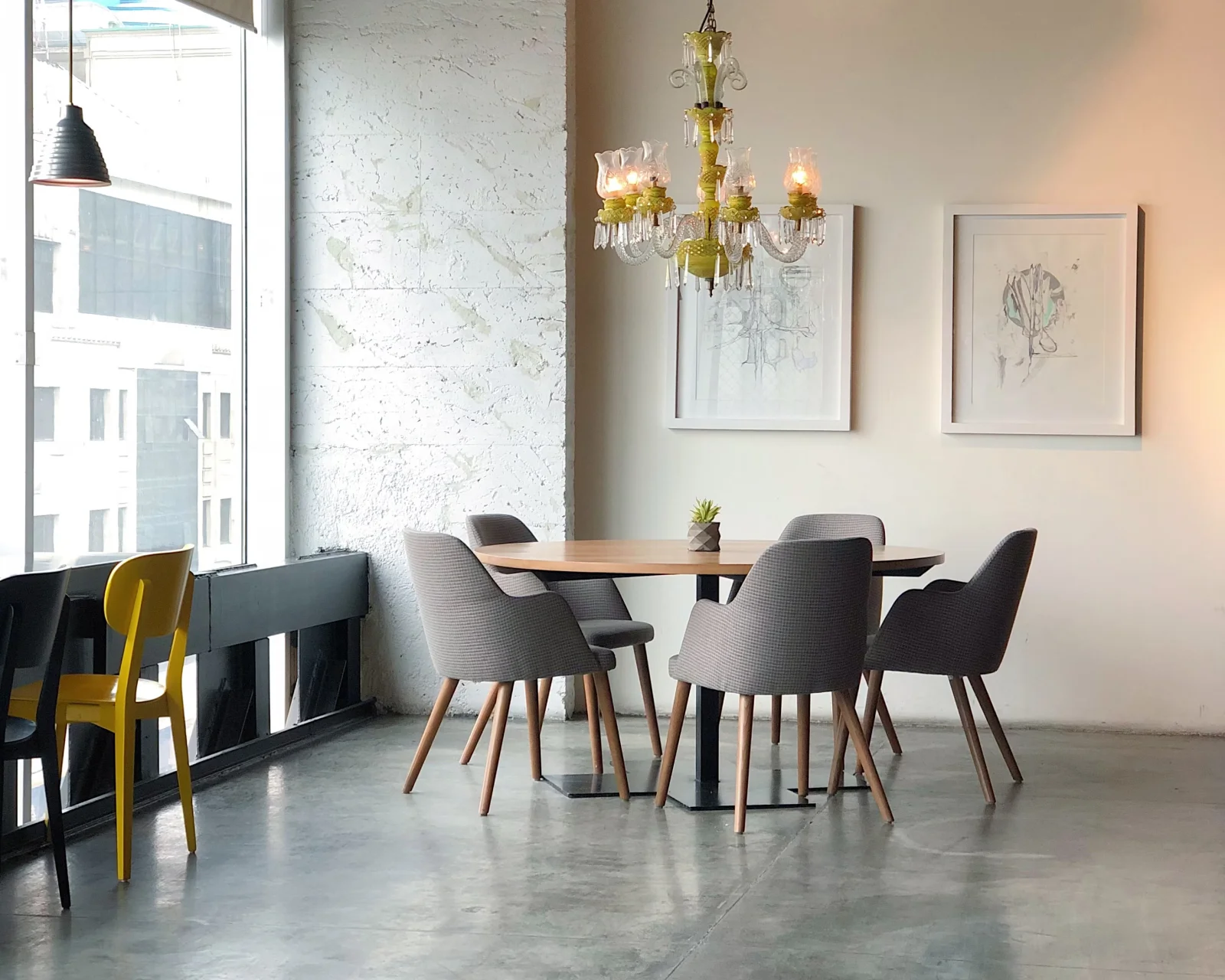 A bunch of different colored chairs in a room.
