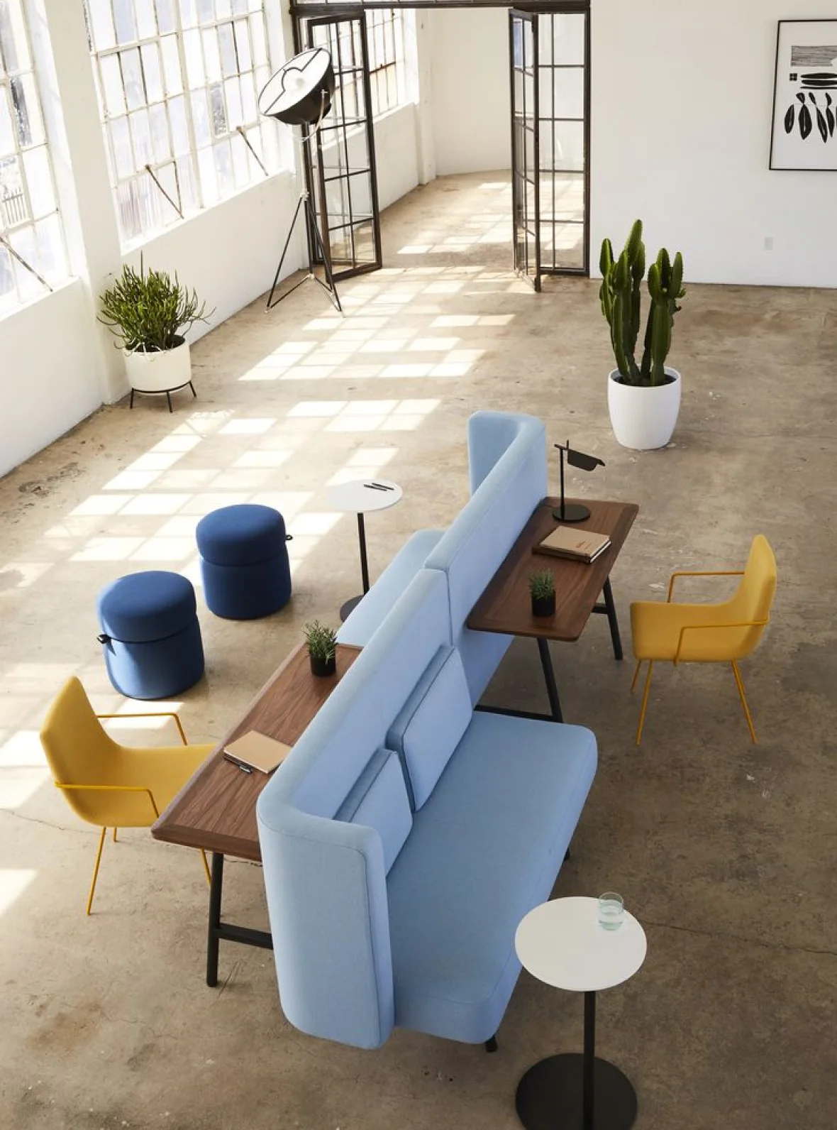 A room with a couch, tables and chairs.